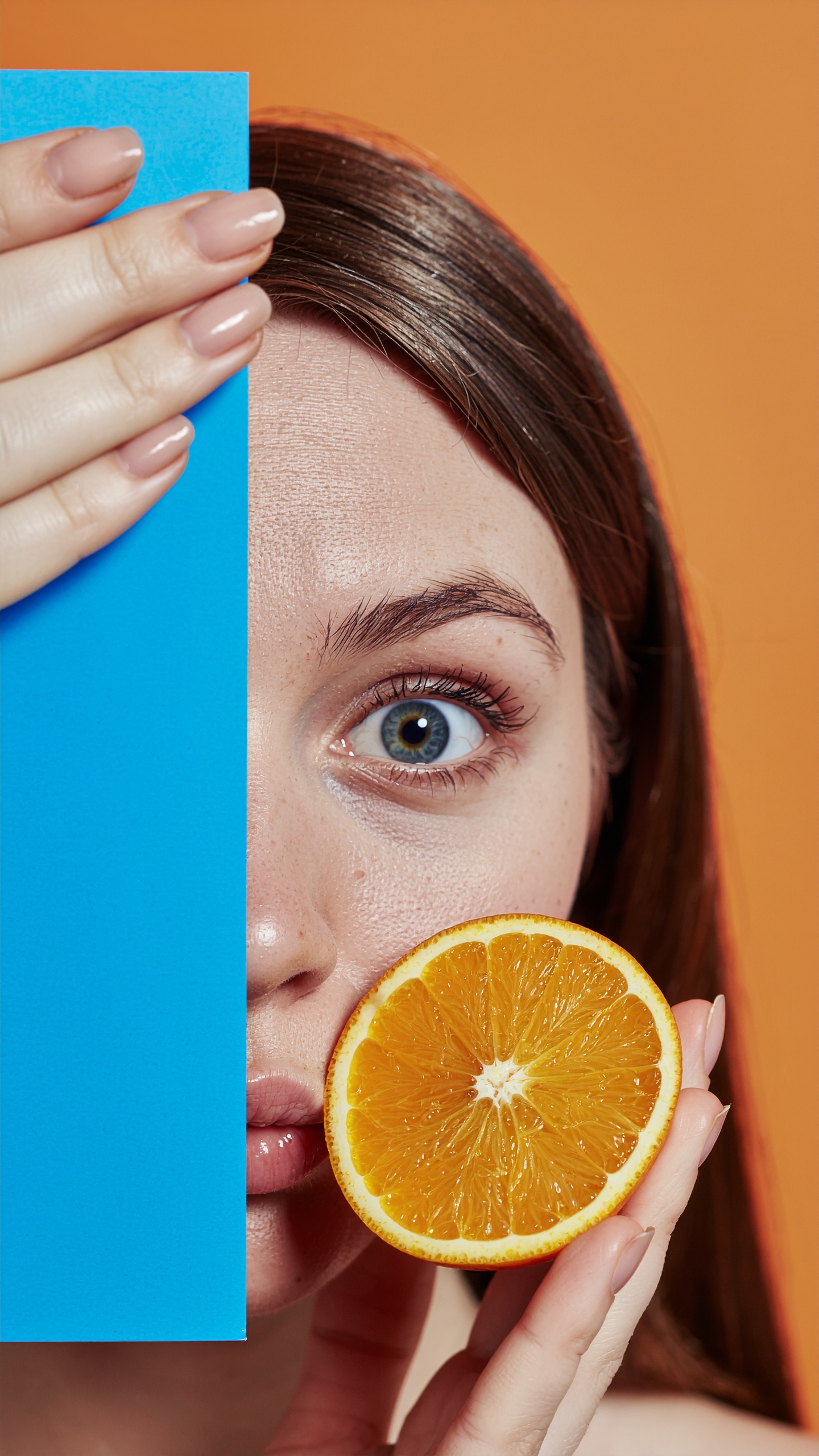 Creative Portrait of a Woman Holding an Orange Slice
